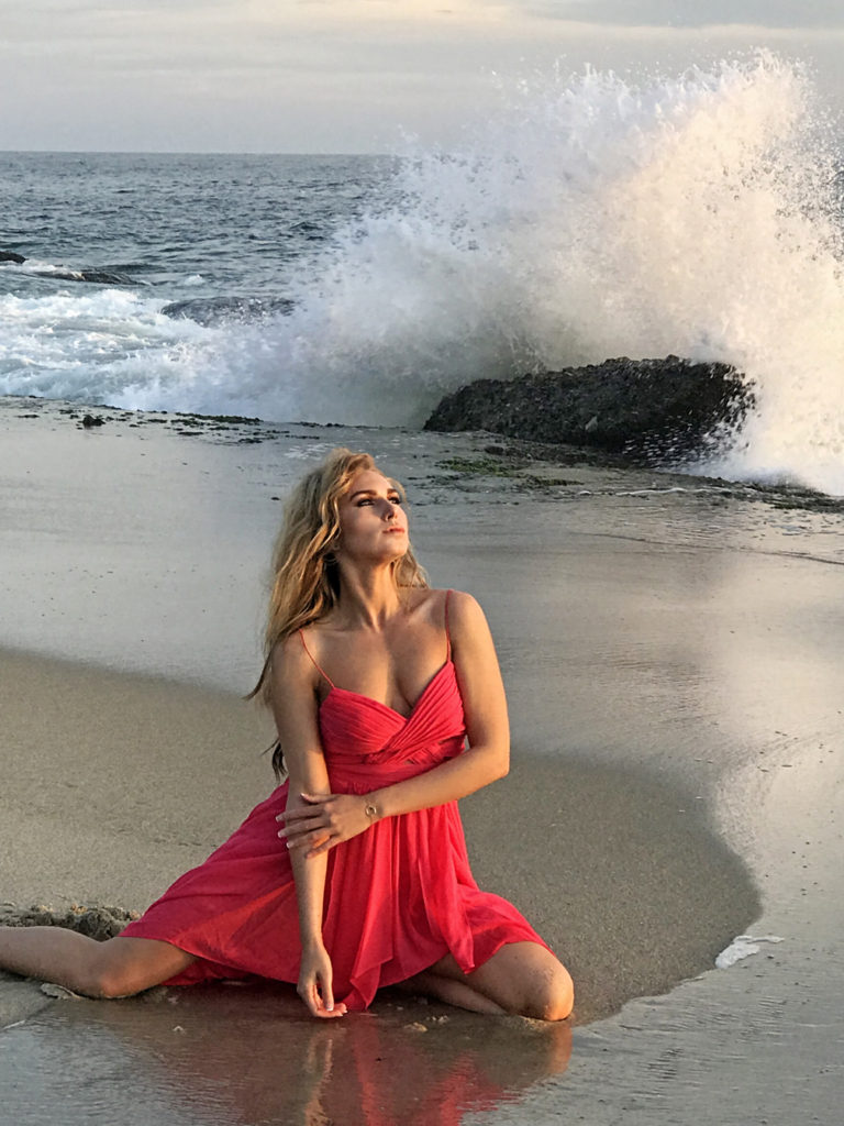 Catching a wave wearing a red dress